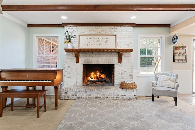 sitting room featuring a fireplace and light colored carpet