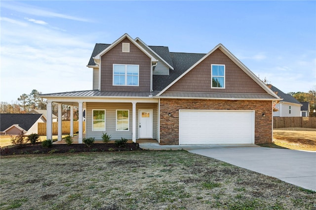 view of front of home featuring a front lawn, covered porch, and a garage