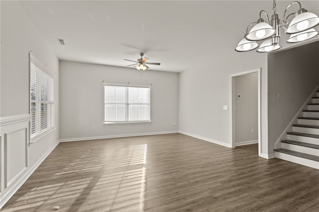 unfurnished living room featuring ceiling fan with notable chandelier and dark hardwood / wood-style floors