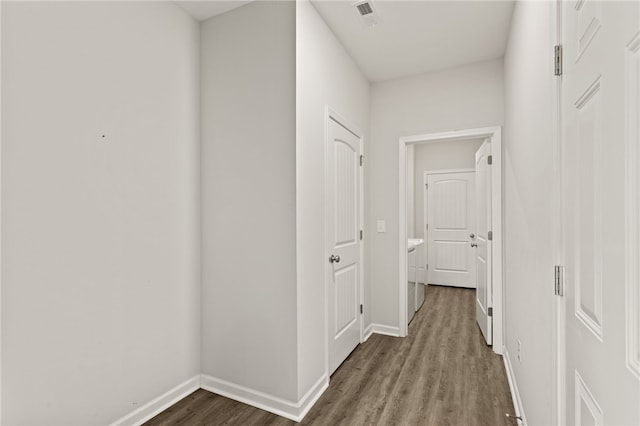 hallway with hardwood / wood-style flooring