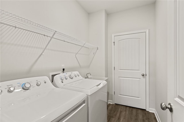 laundry room featuring washer and clothes dryer and dark wood-type flooring