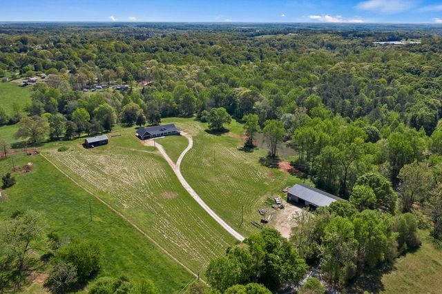 birds eye view of property with a rural view