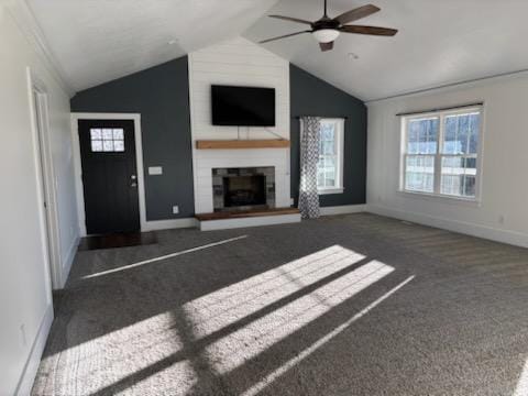 unfurnished living room featuring ceiling fan, a fireplace, dark carpet, and lofted ceiling