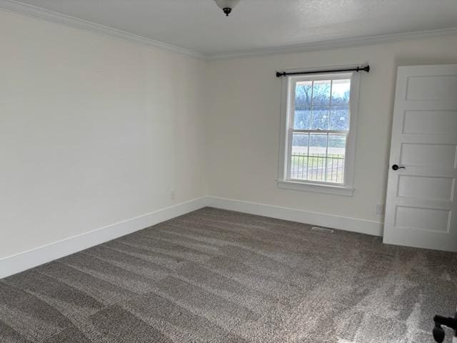 carpeted spare room with crown molding