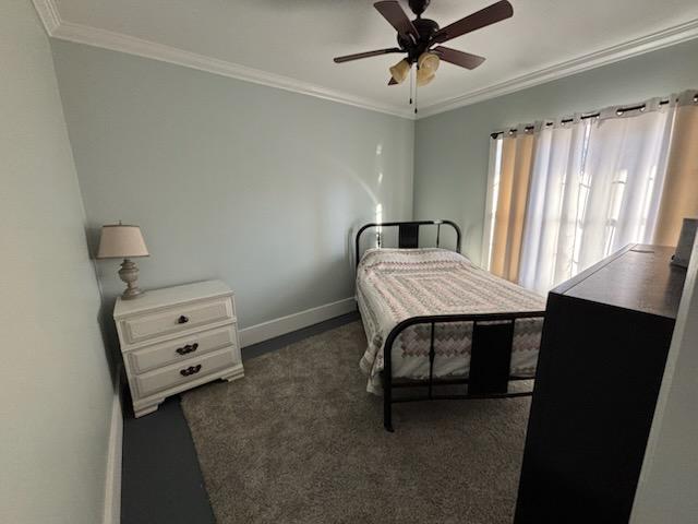 bedroom featuring ceiling fan and ornamental molding