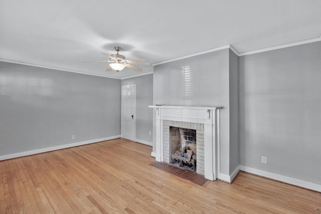 unfurnished living room with a brick fireplace, light hardwood / wood-style flooring, crown molding, and ceiling fan