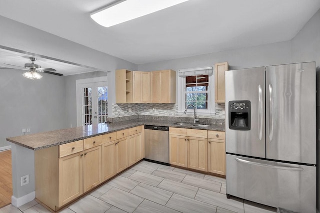 kitchen with kitchen peninsula, ceiling fan, stainless steel appliances, light brown cabinetry, and sink