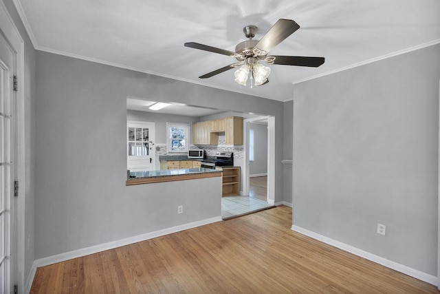 kitchen with kitchen peninsula, stainless steel appliances, decorative backsplash, light brown cabinets, and light hardwood / wood-style flooring