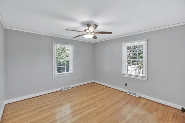 unfurnished room featuring ceiling fan, crown molding, and light hardwood / wood-style flooring