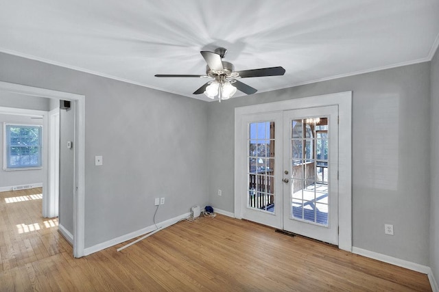 unfurnished room featuring ceiling fan, light hardwood / wood-style flooring, crown molding, and french doors