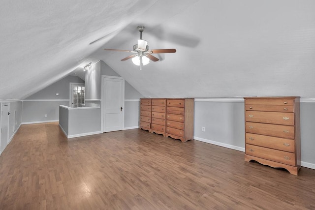 bonus room featuring lofted ceiling, ceiling fan, and dark wood-type flooring