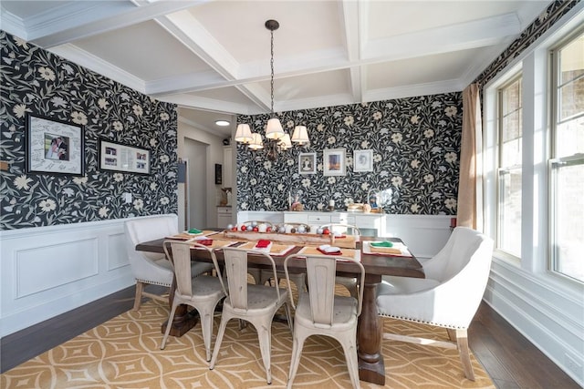 dining space with a notable chandelier, plenty of natural light, wood-type flooring, and coffered ceiling