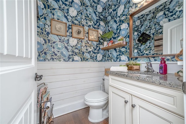 bathroom with vanity, hardwood / wood-style flooring, and toilet