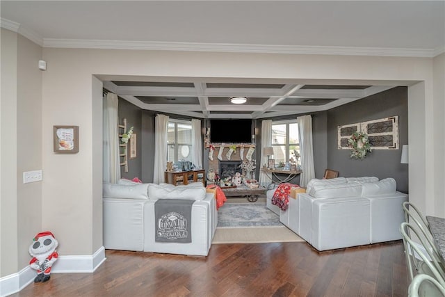 living room featuring ornamental molding, coffered ceiling, and hardwood / wood-style flooring