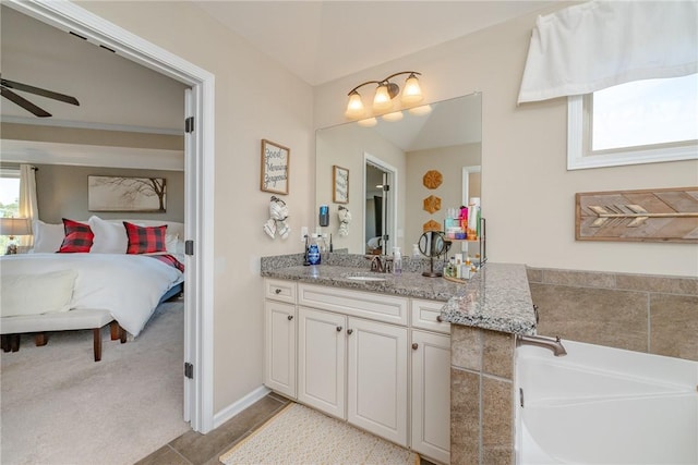 bathroom featuring ceiling fan, tile patterned flooring, vanity, and a washtub