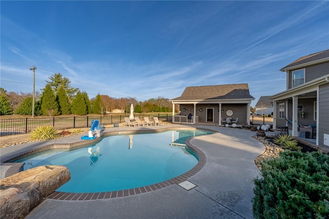 view of pool with a patio and an outdoor structure