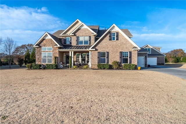 craftsman house featuring a porch and a garage