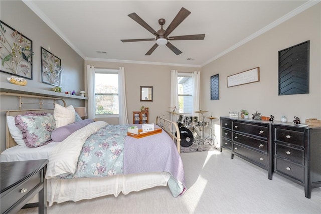 bedroom featuring multiple windows, ceiling fan, crown molding, and light colored carpet