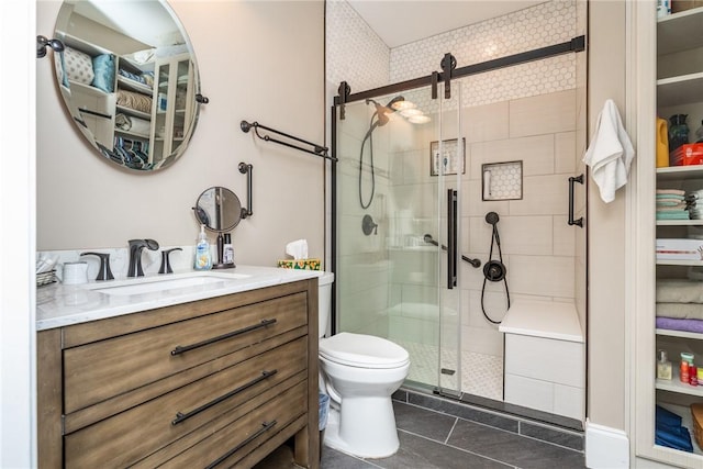 bathroom with tile patterned flooring, vanity, an enclosed shower, and toilet