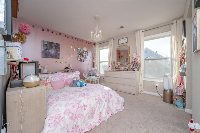 carpeted bedroom with a notable chandelier