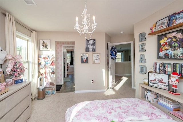 bedroom featuring carpet floors and an inviting chandelier