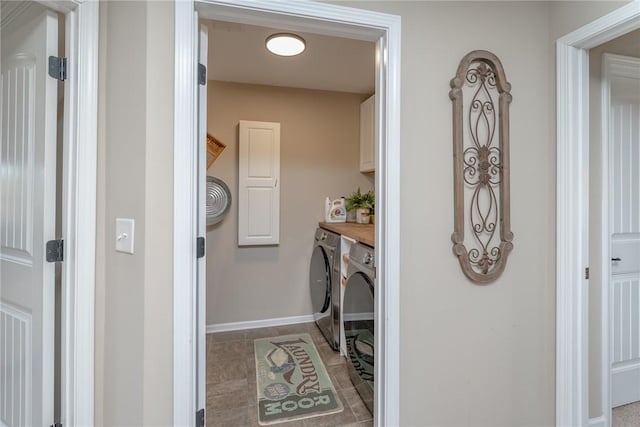 laundry area featuring cabinets and washer and clothes dryer