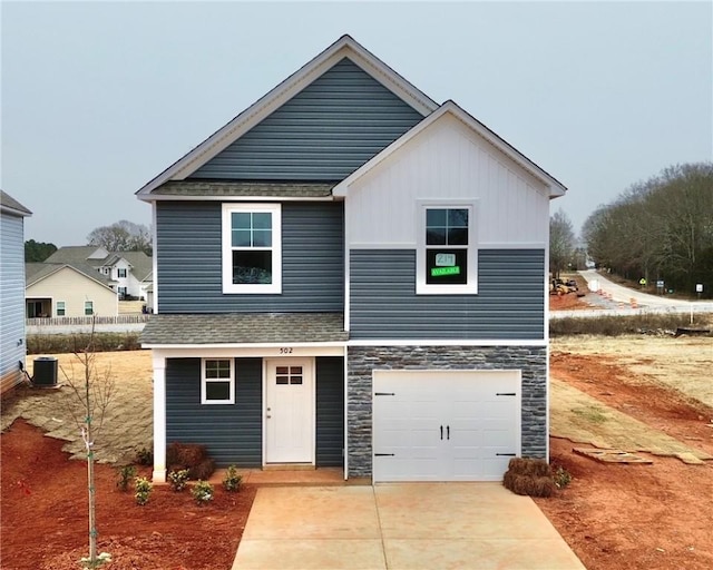 view of front facade featuring cooling unit and a garage