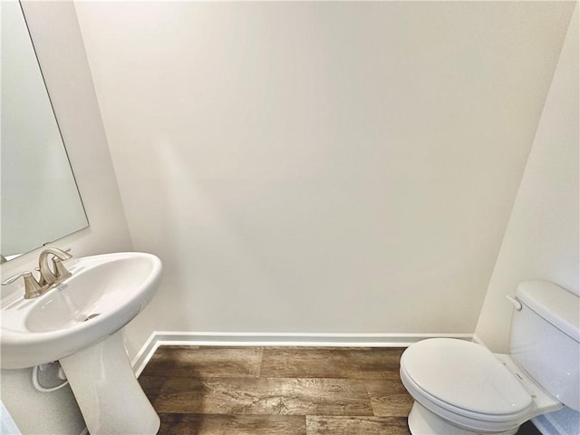 bathroom with sink, hardwood / wood-style flooring, and toilet