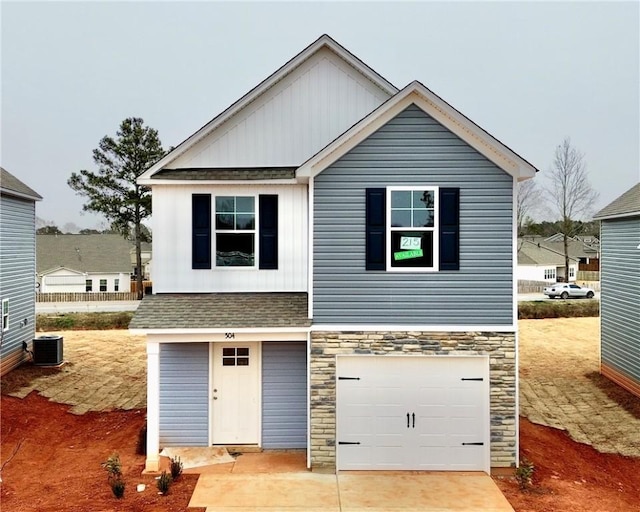 view of front of house featuring central AC unit and a garage