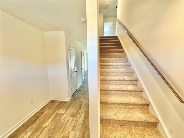 stairs with wood-type flooring