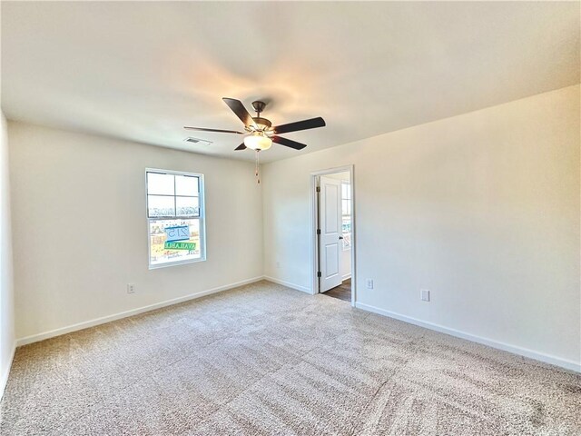 empty room with carpet and ceiling fan