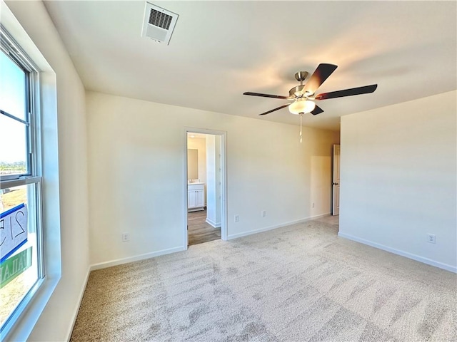 carpeted spare room with ceiling fan