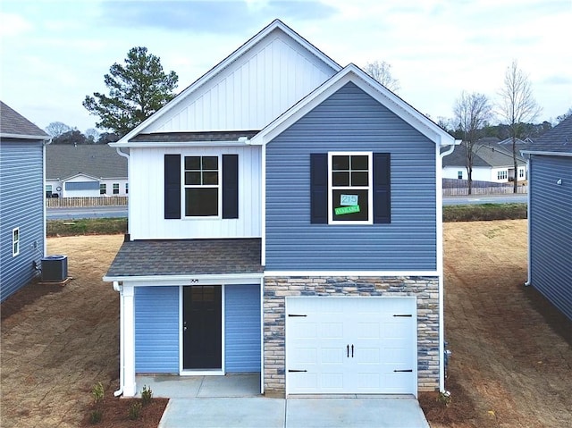 view of front of home featuring a garage and central AC