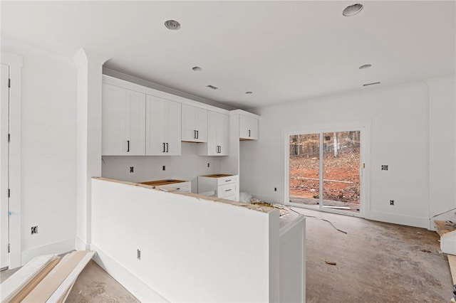 kitchen with white cabinetry and kitchen peninsula