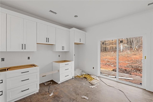 kitchen with crown molding and white cabinets