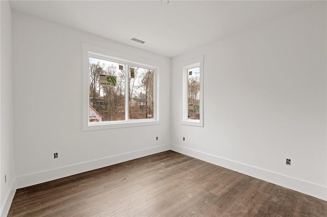 spare room featuring dark wood-type flooring