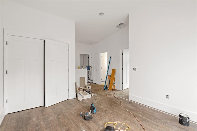 unfurnished bedroom featuring a closet and hardwood / wood-style flooring