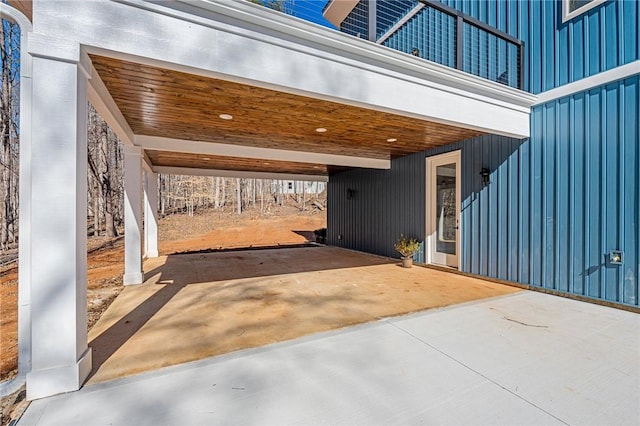 view of patio featuring a carport and concrete driveway