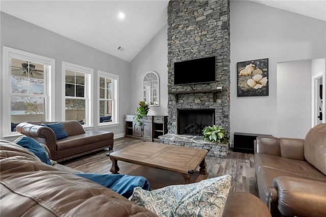 living room with ceiling fan, a fireplace, high vaulted ceiling, and hardwood / wood-style floors