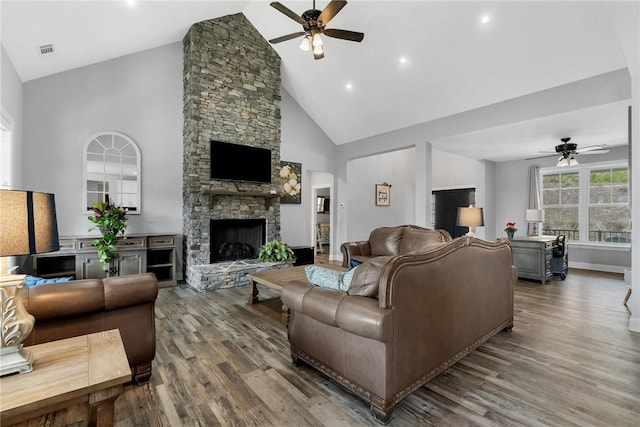 living room featuring hardwood / wood-style flooring, ceiling fan, a fireplace, and high vaulted ceiling