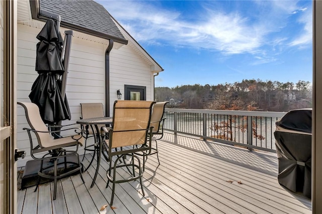 wooden terrace with a grill