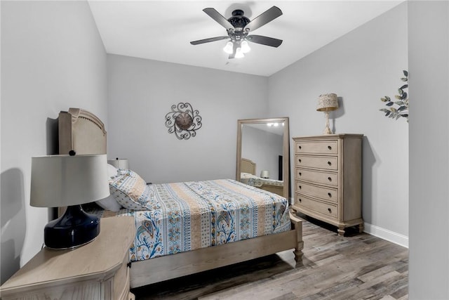 bedroom with ceiling fan and wood-type flooring