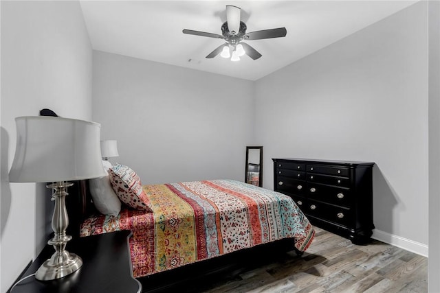 bedroom with hardwood / wood-style floors and ceiling fan