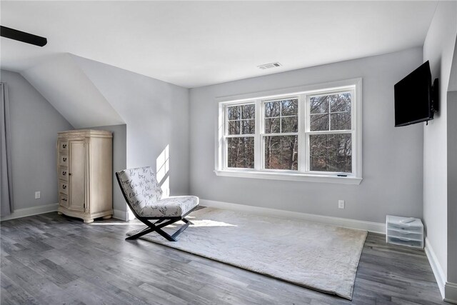 unfurnished room with dark hardwood / wood-style flooring and lofted ceiling