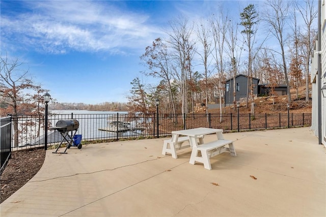 view of patio / terrace with area for grilling and a water view