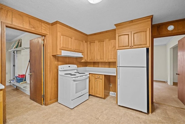 kitchen with white appliances, a textured ceiling, and ornamental molding