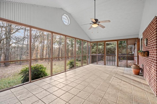 unfurnished sunroom with ceiling fan and lofted ceiling