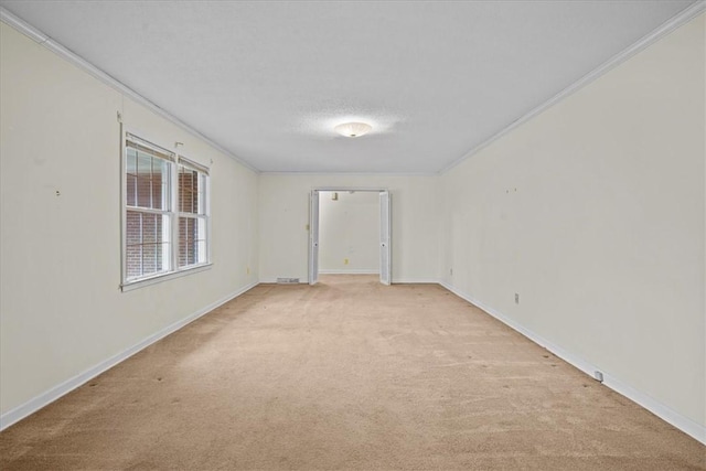 carpeted spare room featuring a textured ceiling and ornamental molding