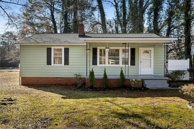 view of front of house with a front yard and covered porch