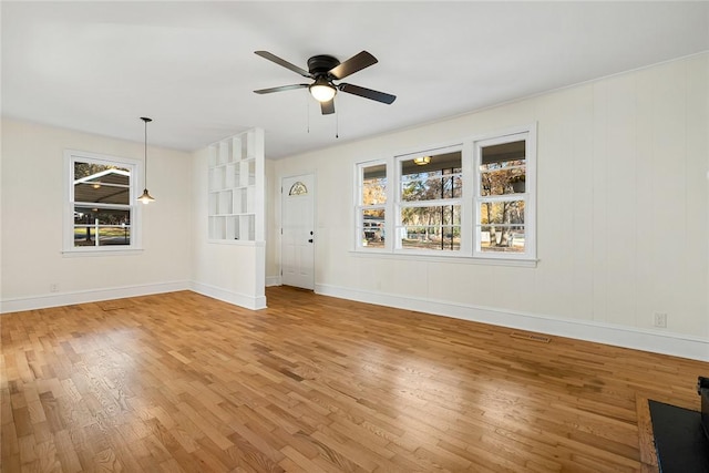 unfurnished living room with ceiling fan and wood-type flooring